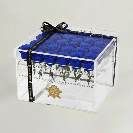 Clear box with blue roses and a visible brand logo on a white background