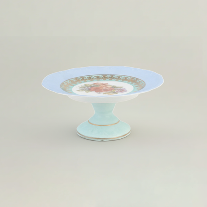 Decorative cake stand with floral design on a light gray background