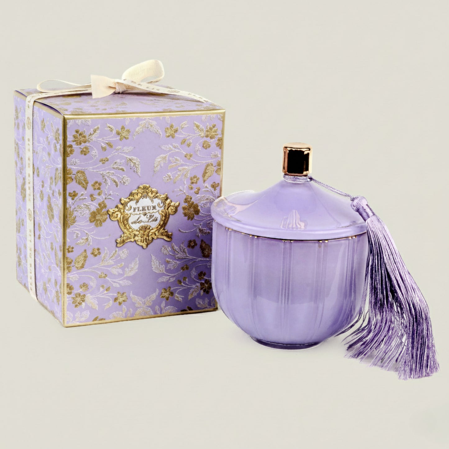 Lavender-colored perfume bottle with decorative box on a light background