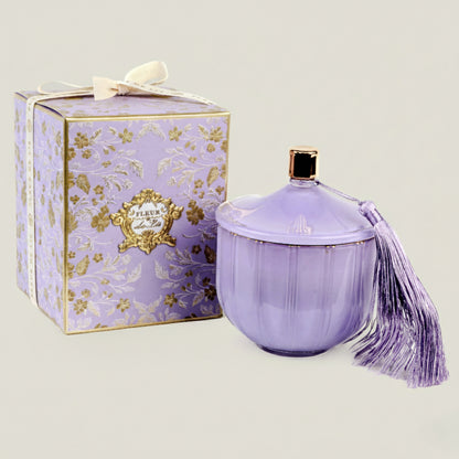 Lavender-colored perfume bottle with decorative box on a light background