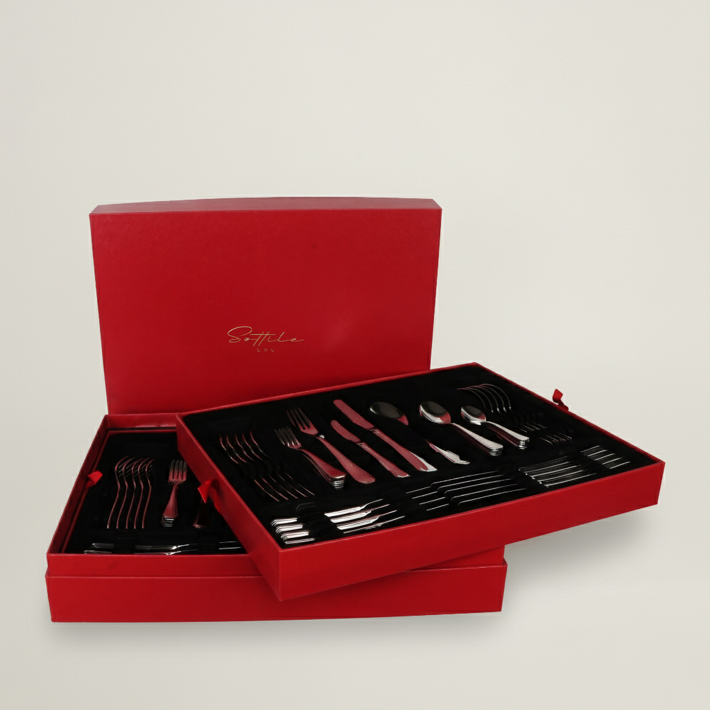 Silver cutlery set in an open red box on a light gray background