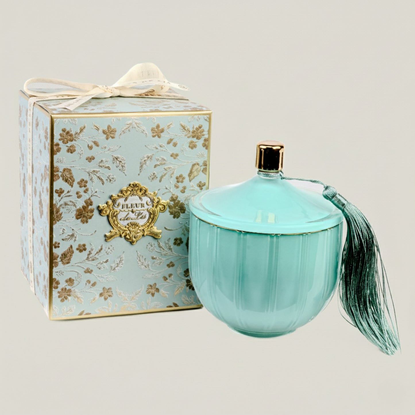 Turquoise perfume bottle with decorative box on a light gray background