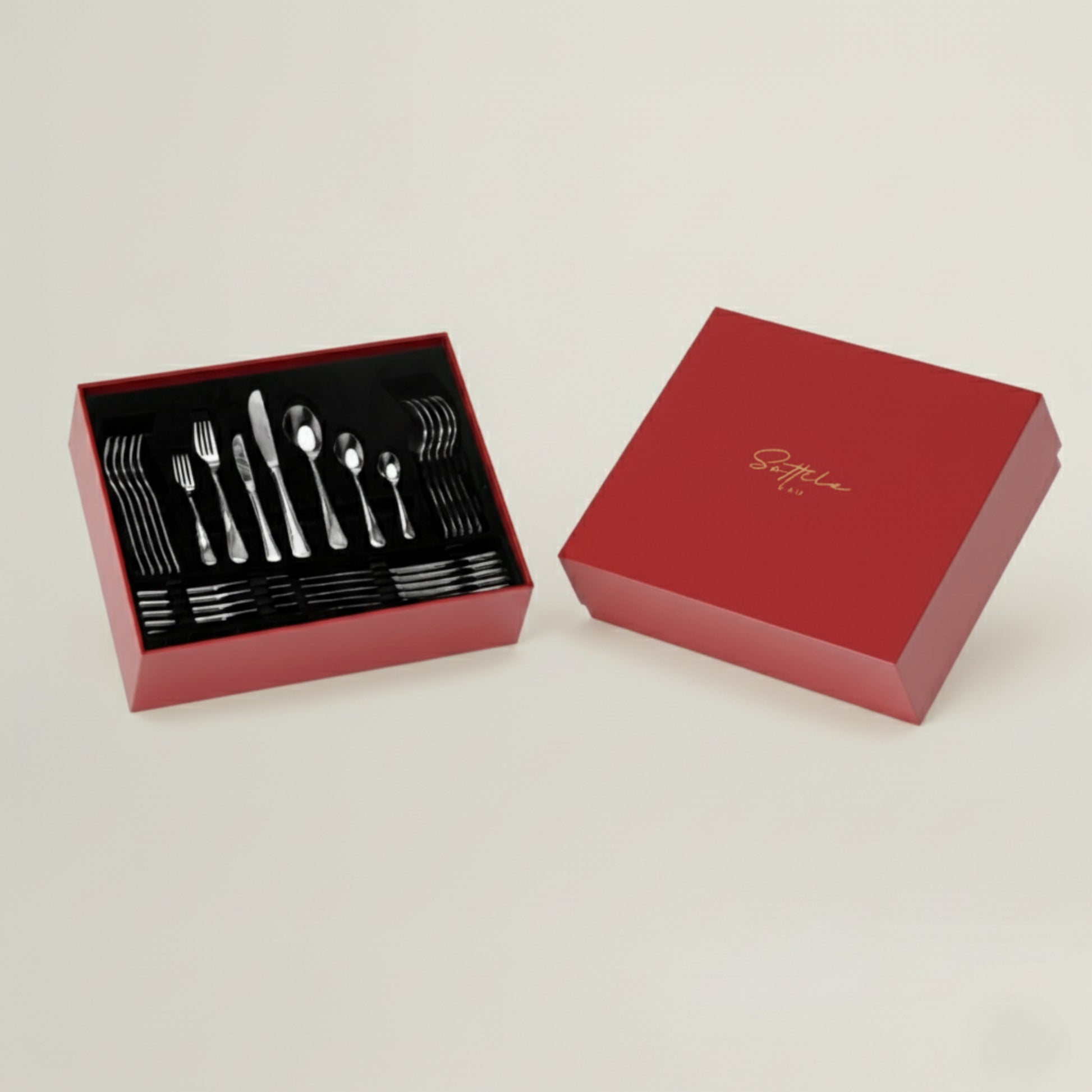 Red box with silverware set on a light beige background