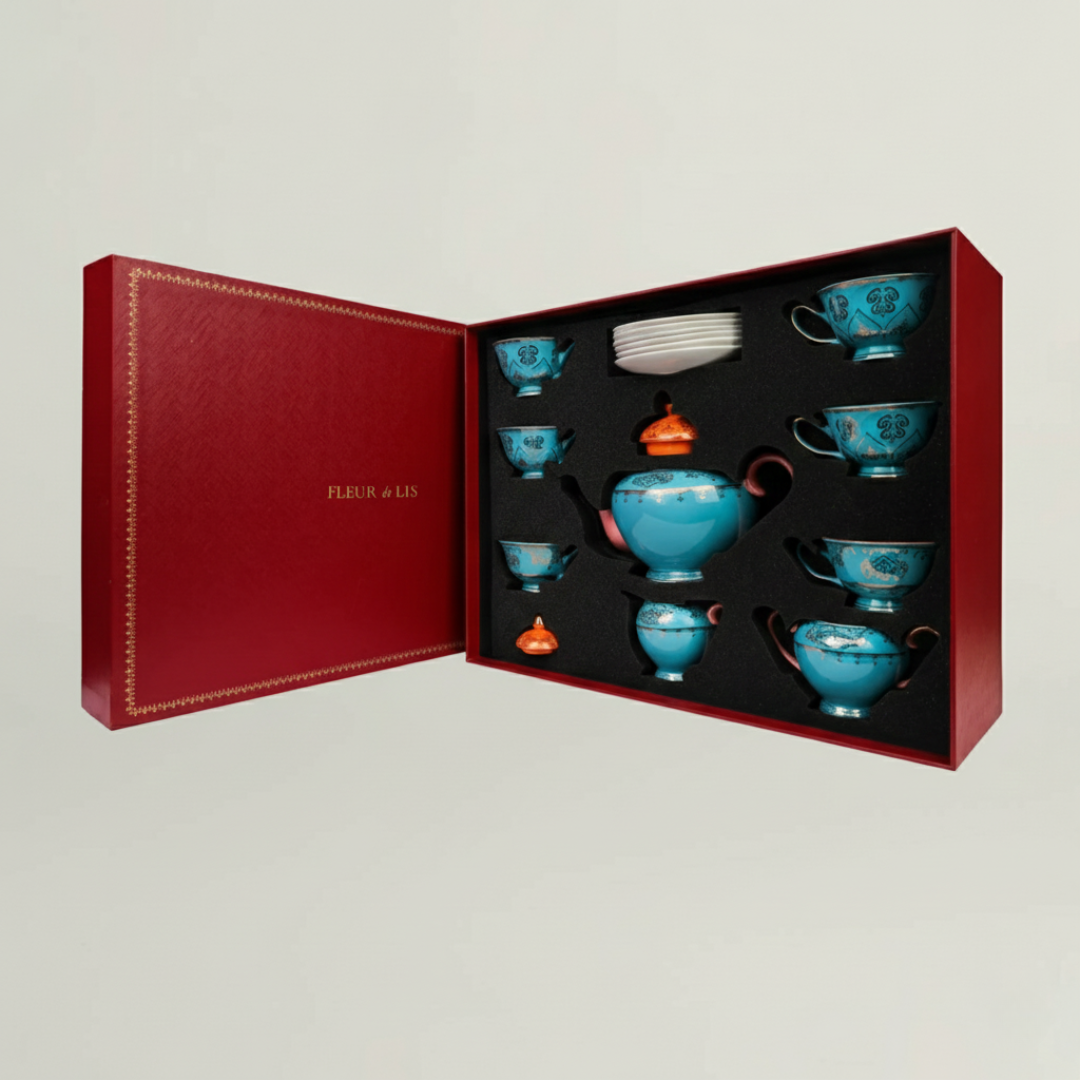 Luxury ceramic tea set in orange and turquoise tones, presented in a handcrafted Fleur de Lis gift box.